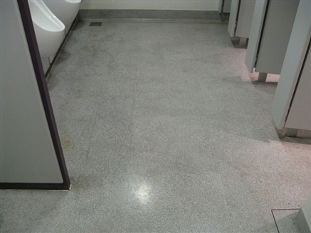 Dull and dirty appearance in the Gents' toilets with visible uric acid stains under the urinals.