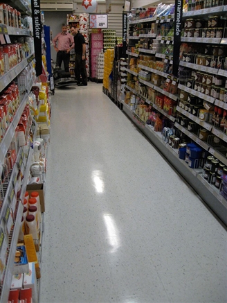 Look closely and you will see the result of UHS Burnishing. The whole aisle has had a polish treatment, the left hand side has been burnished whereas the right hand side hasn't. 